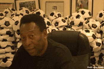 Pele poses with soccer balls