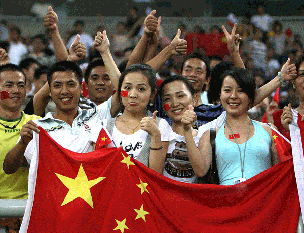 chinese football fans hold a flag
