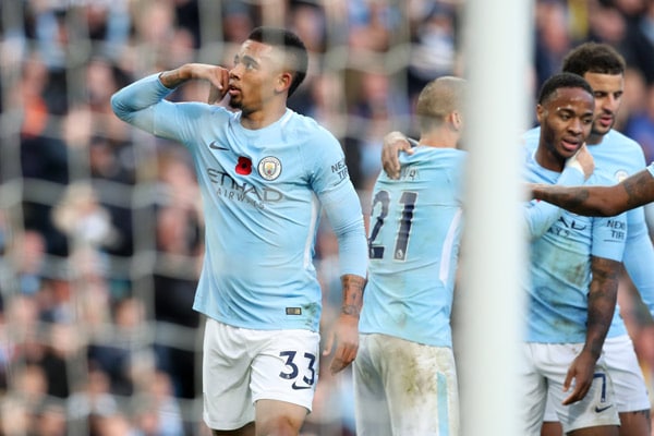 manchester city players celebrate scoring 