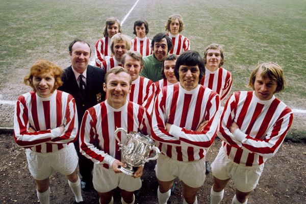 stoke city players pose with league cup trophy