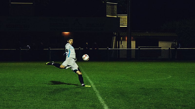 soccer player strikes the ball