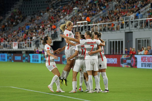 women soccer players celebrate